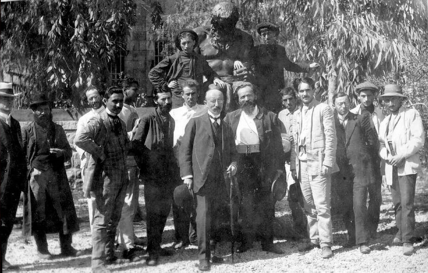 Group photograph of Boris Schatz and Bezalel Academy students gathered in a garden setting, early twentieth century