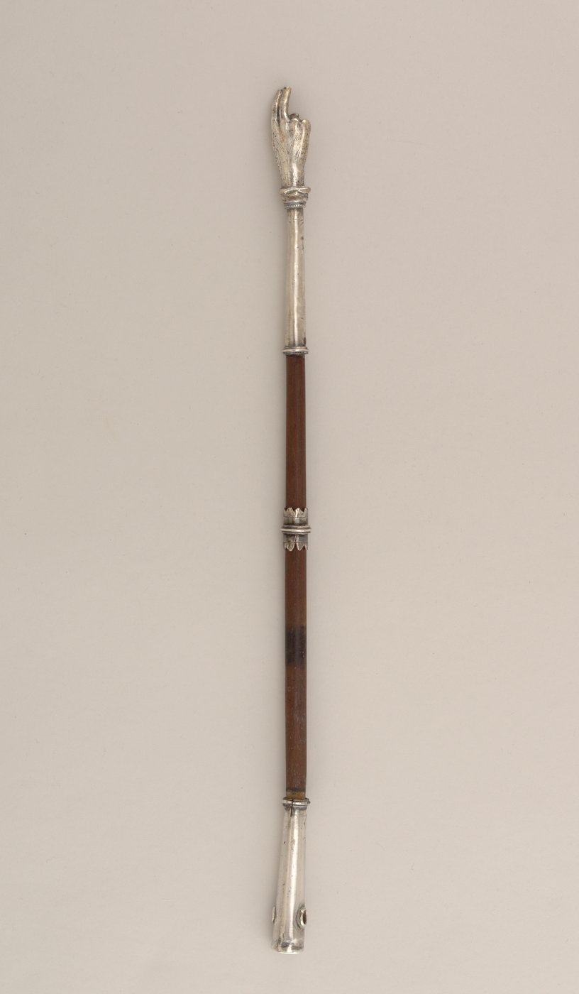 Antique silver Torah pointer ending in a small carved hand.