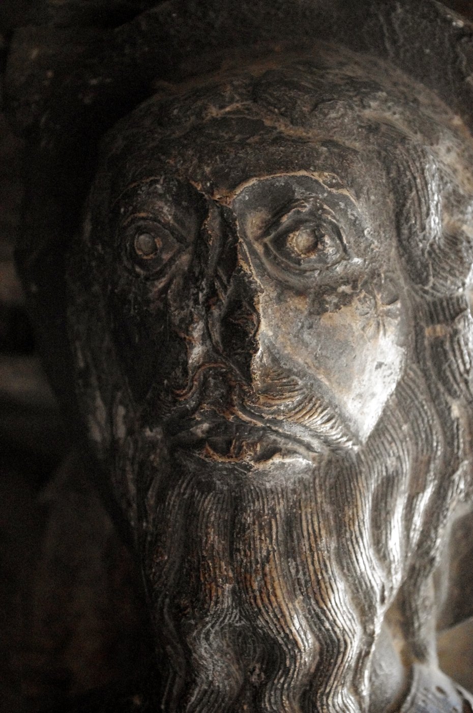 Weathered Romanesque stone head identified as Gamaliel.