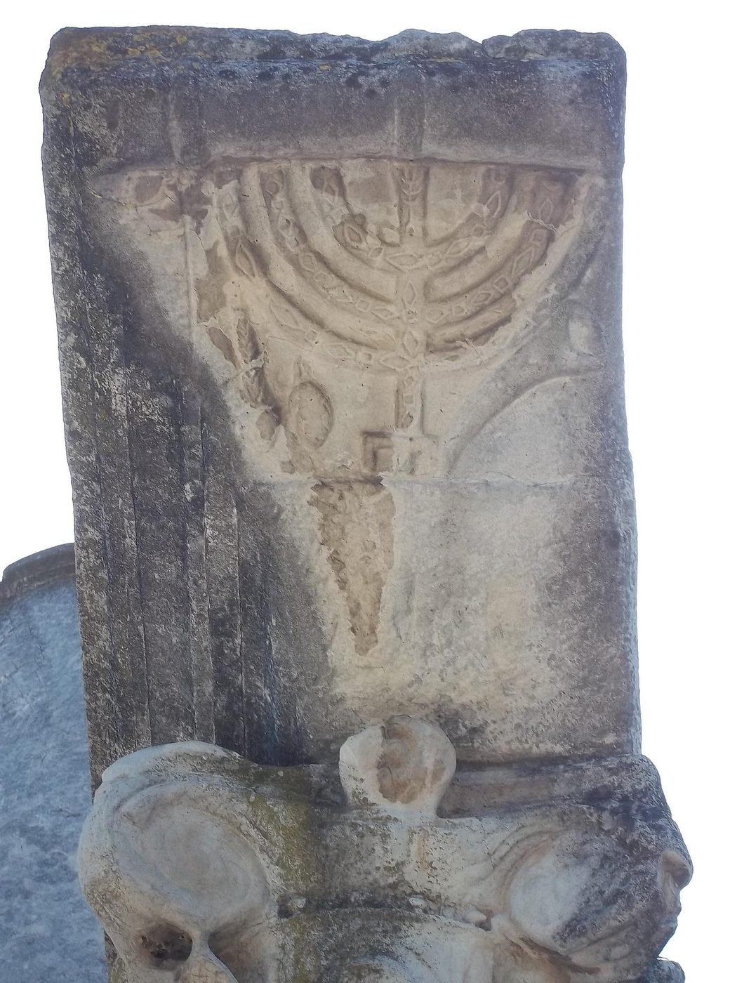 Carved seven-branched menorah in relief on a marble column capital from the Ostia Antica synagogue ruins