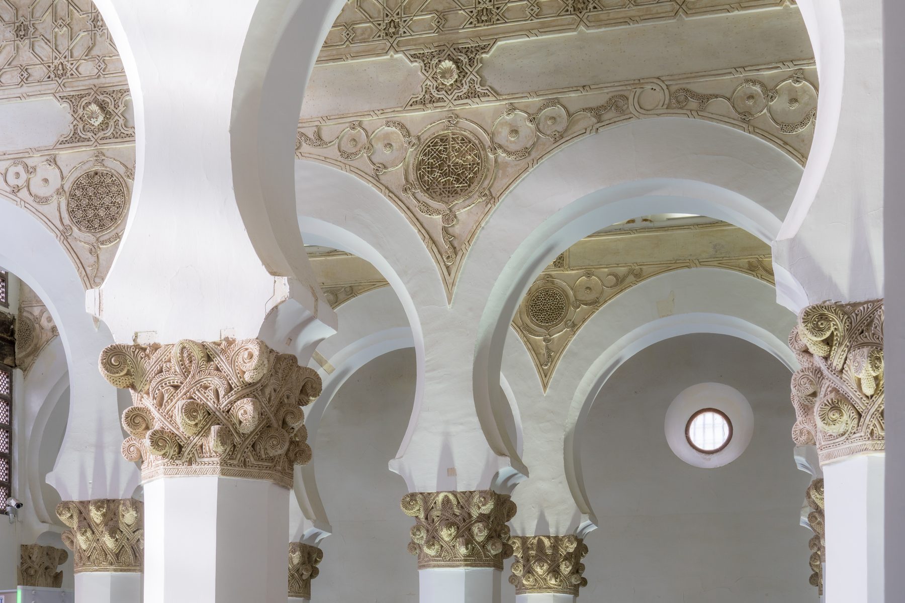 Interior detail of horseshoe arches and decorated capitals at Santa Maria la Blanca, Toledo.