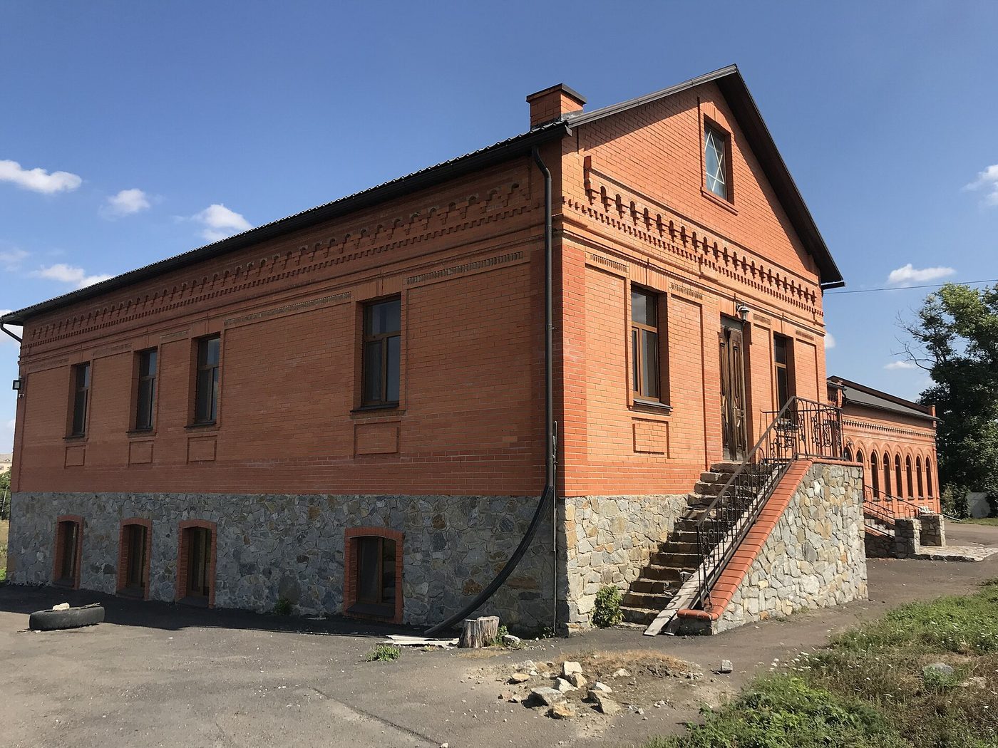 Today, the restored Skver Beth midrash in Skvyra under a clear sky.