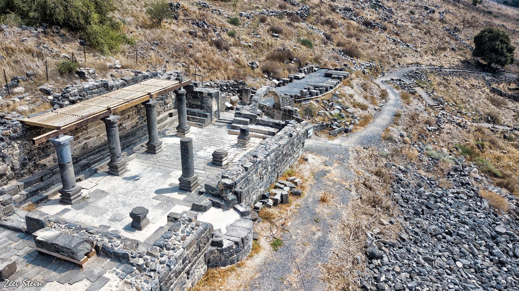 Reconstructed basalt structures, columns and paved floor of the Deir Aziz synagogue in the Golan Heights.