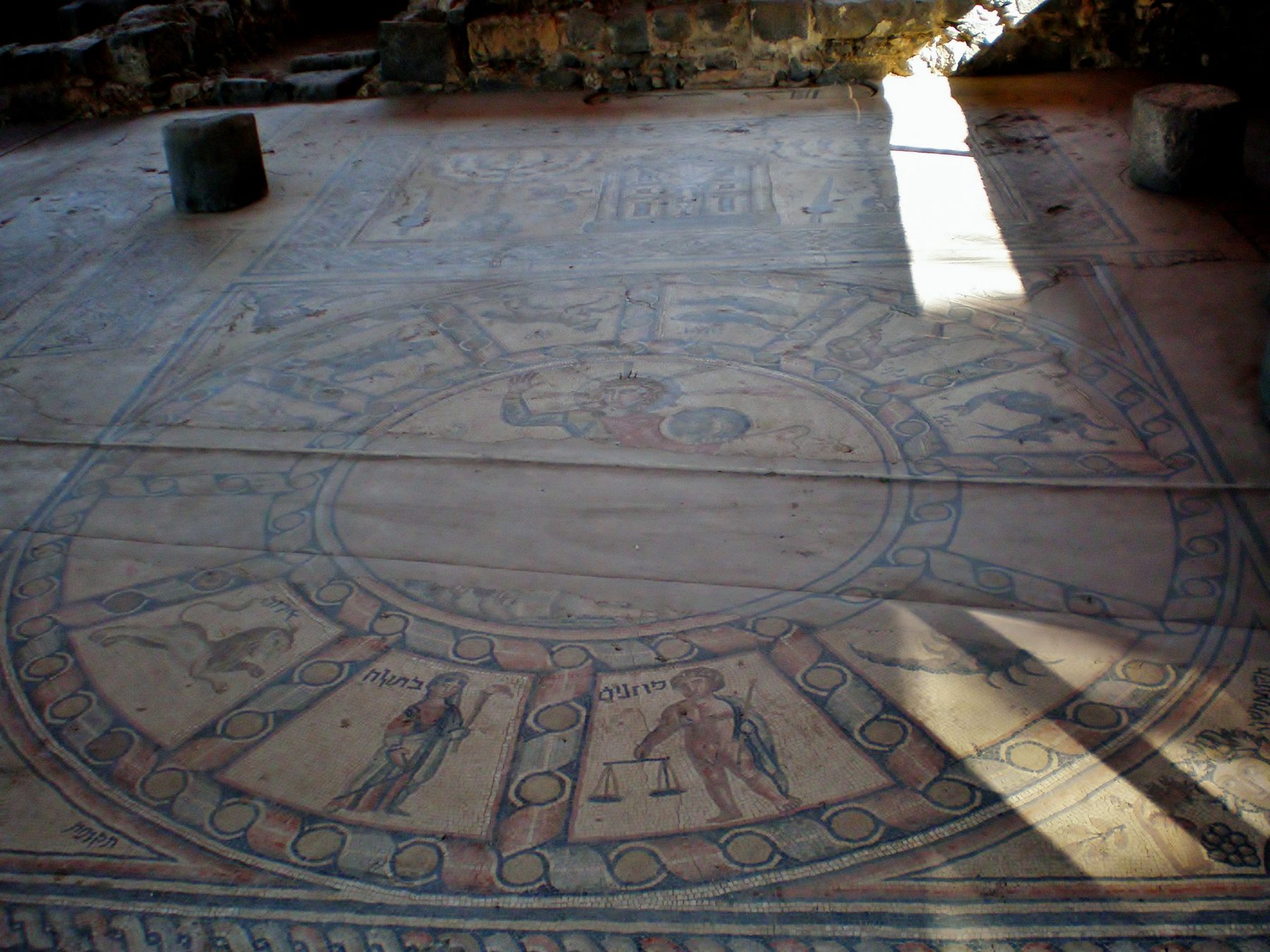 The zodiac mosaic floor of the fourth-century synagogue at Hammath Tiberias, showing Helios in a chariot at the centre surrounded by the twelve zodiac signs in Hebrew