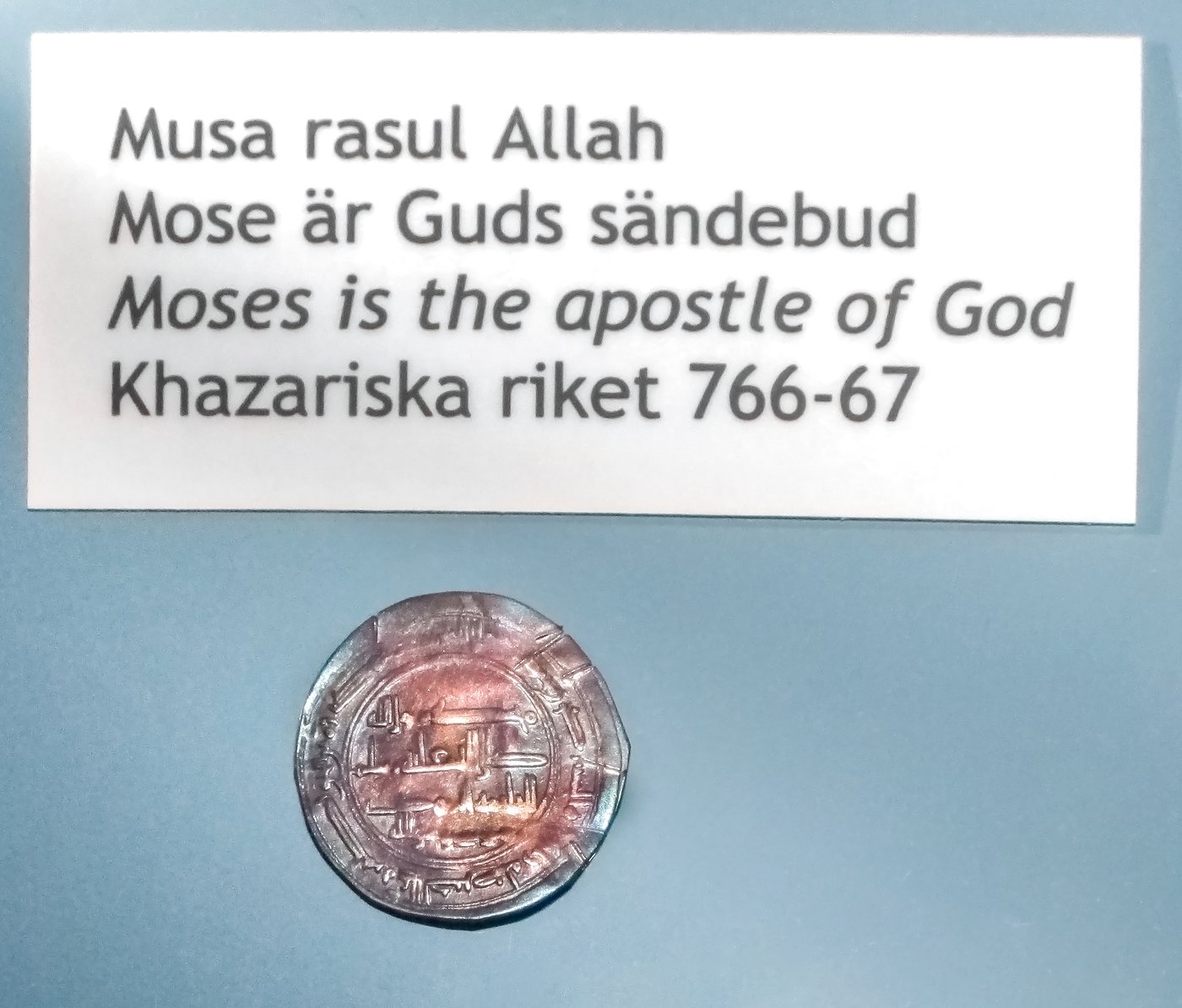 Two silver coins with Arabic inscriptions, shown with a museum tag.