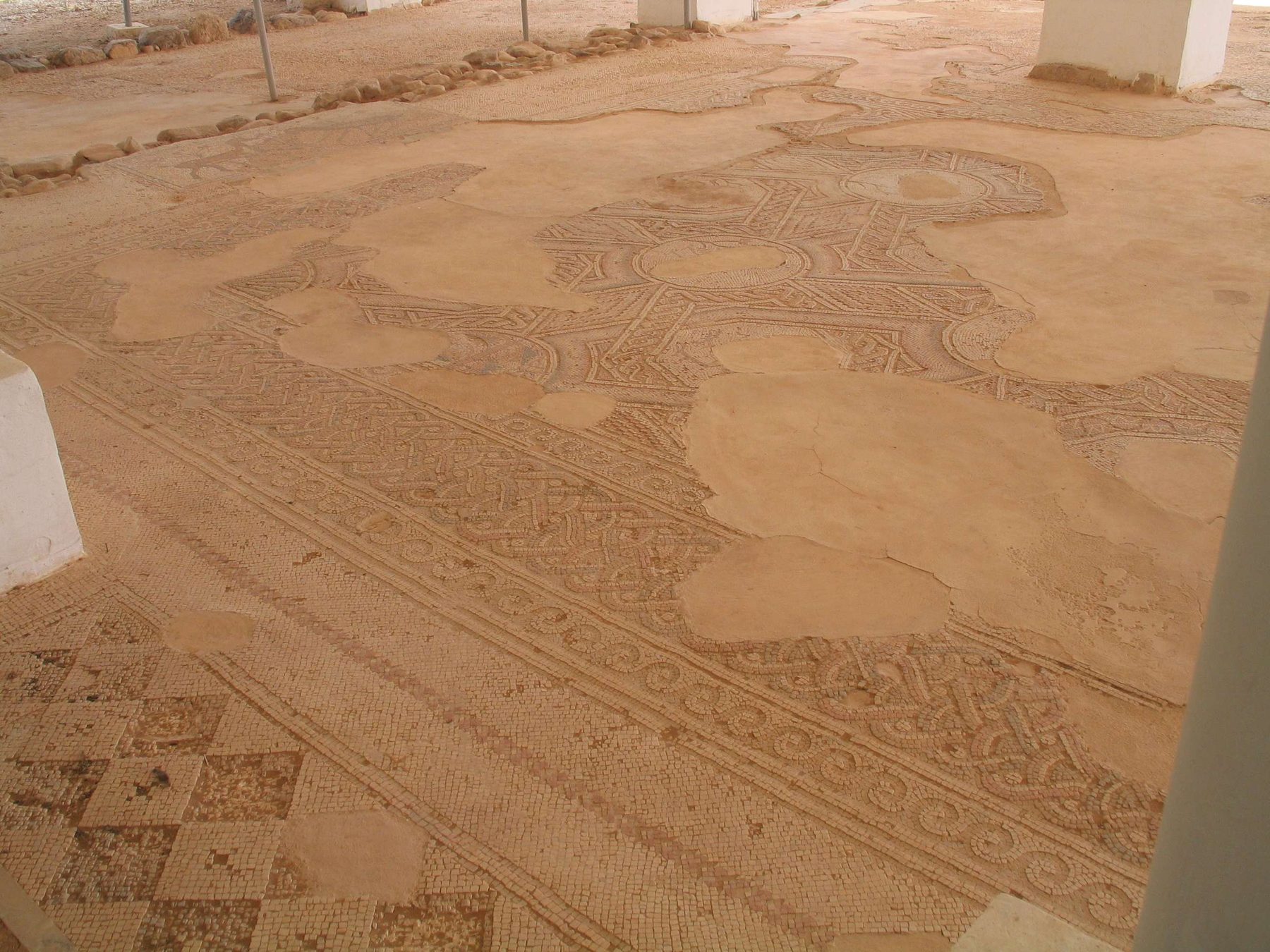 The mosaic floor of the ancient synagogue at Naaran, showing the zodiac wheel with defaced figural panels and preserved inscriptions.