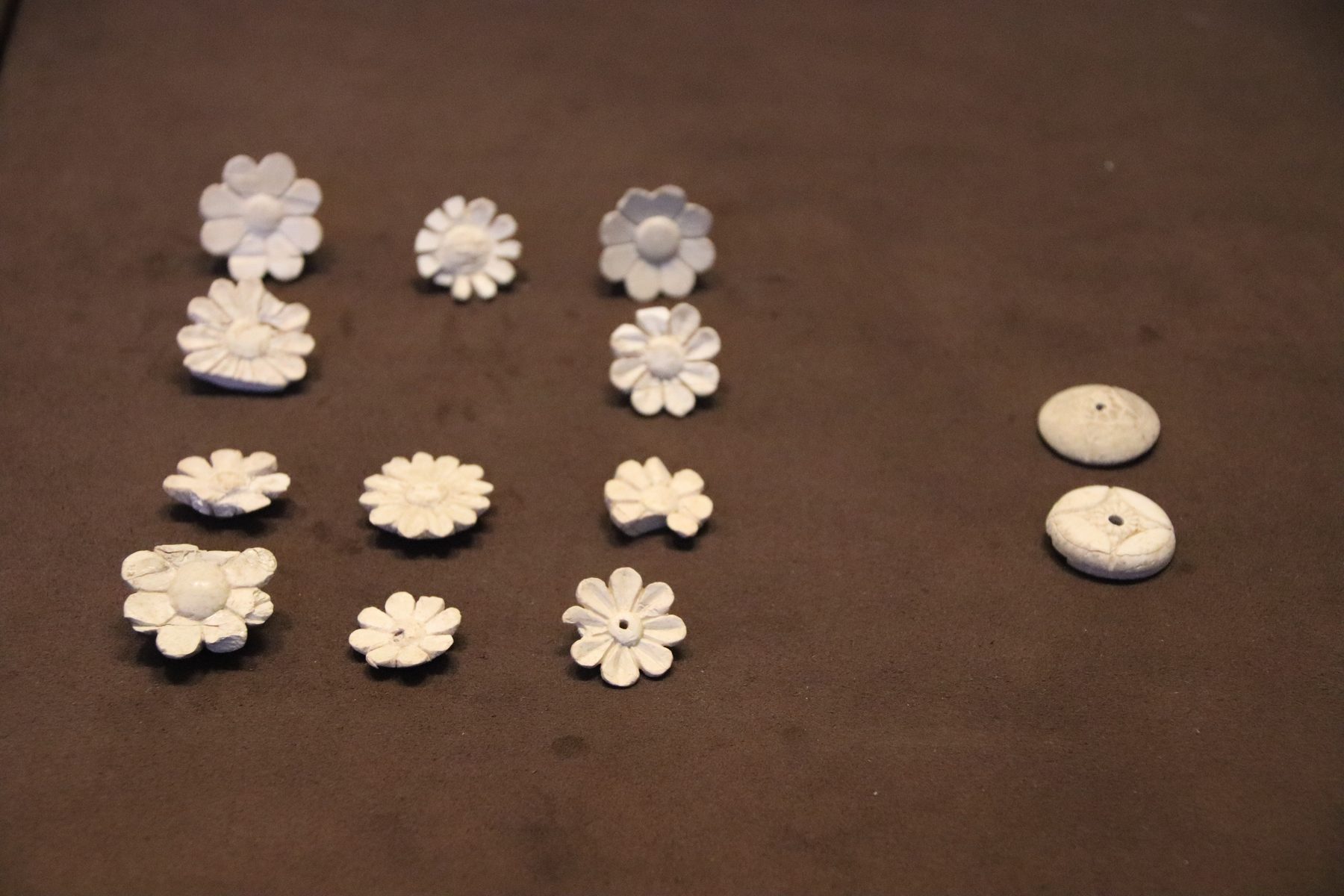 Carved ivory inlay pieces from the royal palace at Samaria, including flower-shaped and disc-shaped decorative forms