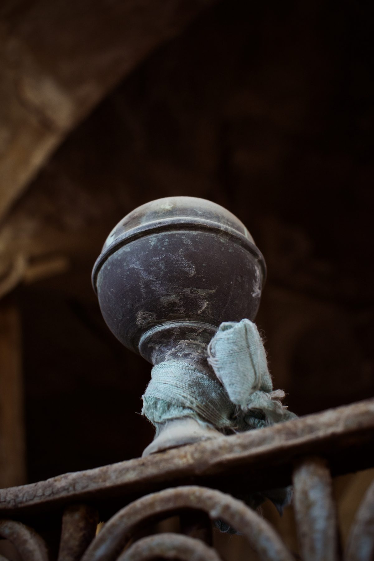 A brass finial wrapped with pale blue-green cloth, decorating the interior of the tomb-shrine at Alqosh.