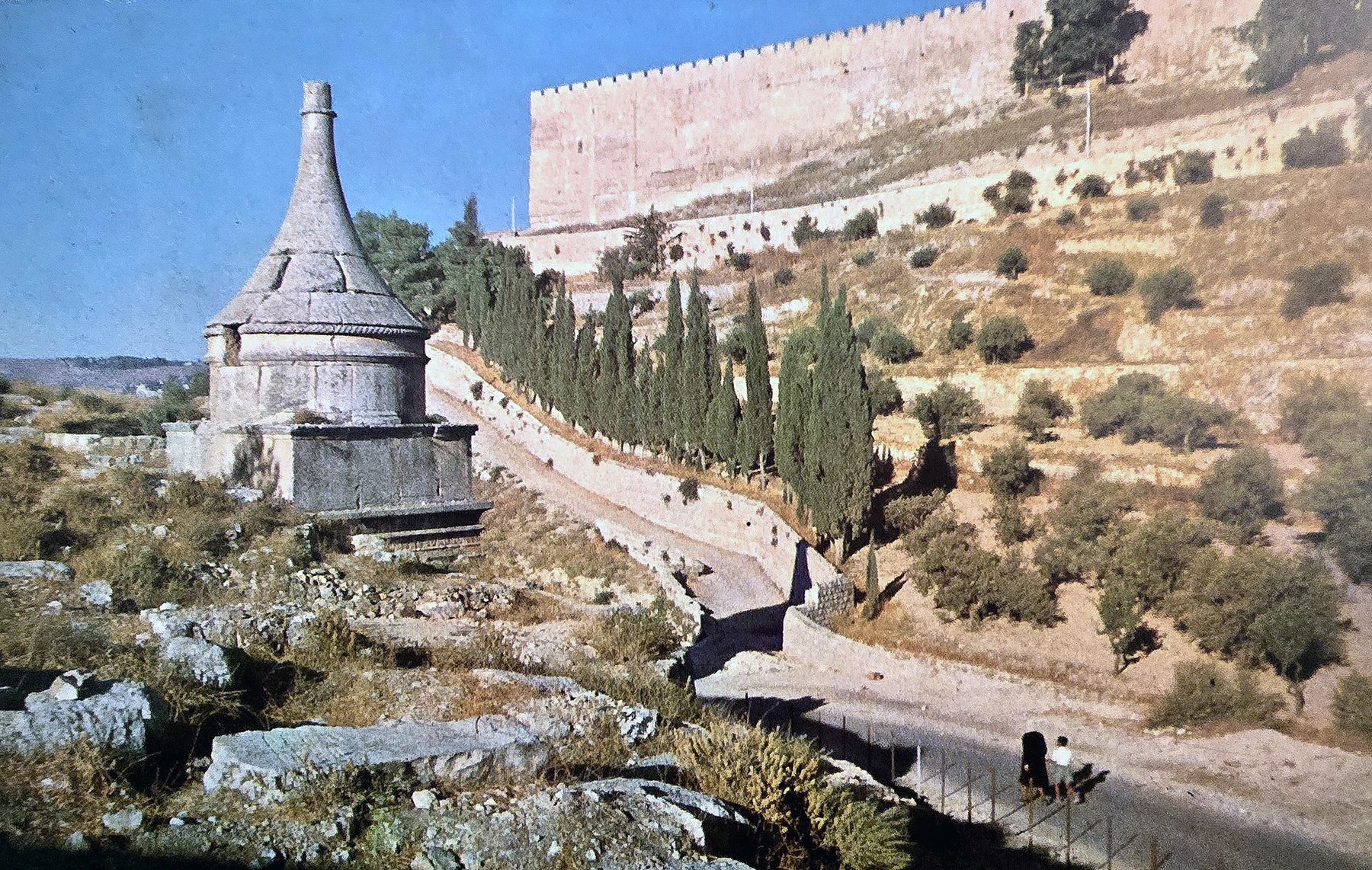 Absalom's Pillar and other monumental rock-cut tombs of the Kidron Valley, Jerusalem, with cypress trees and the Old City wall visible in the background.