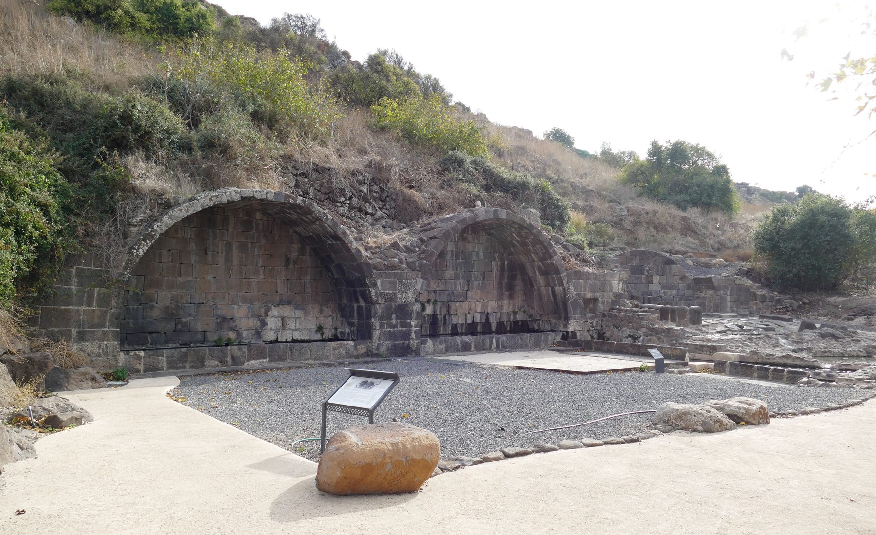 Stone barrel-vaults of the reconstructed Umm el-Qanatir synagogue showing numbered stones laid out in archaeological anastylosis restoration.