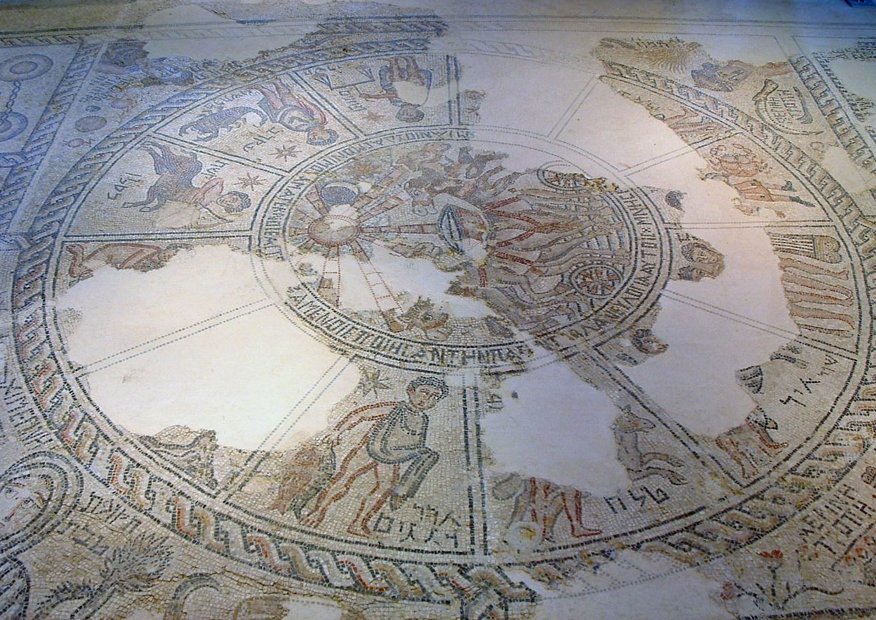 Zodiac calendar mosaic floor from the ancient synagogue at Tzippori, showing twelve zodiac signs around a central Helios figure with Hebrew labels for months and seasons