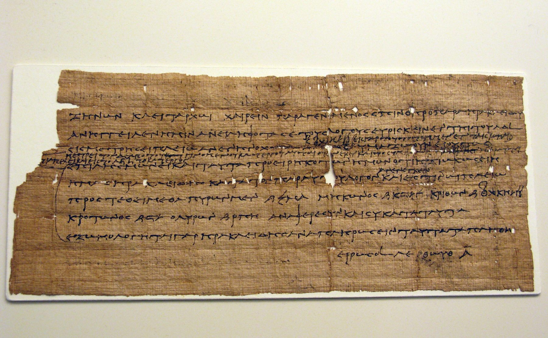 Fragment of a Greek papyrus with black ink text, showing multiple lines of administrative handwriting from the 3rd century BC.