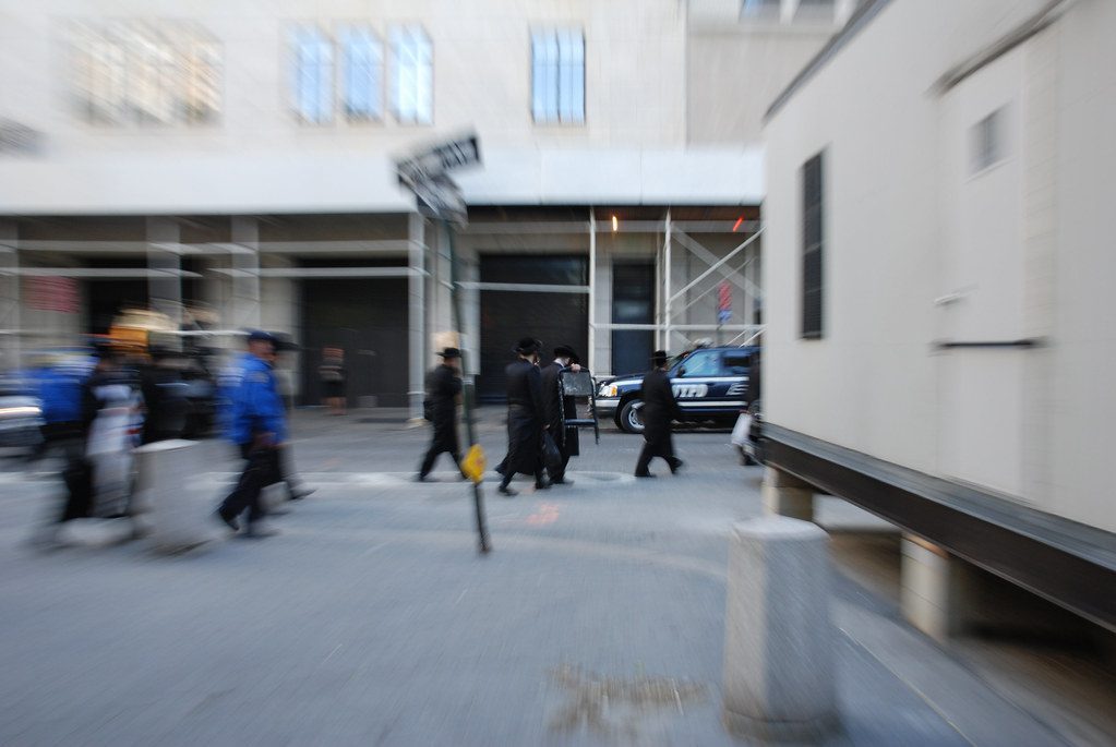 Hasidic men crossing a street in Williamsburg, Brooklyn.